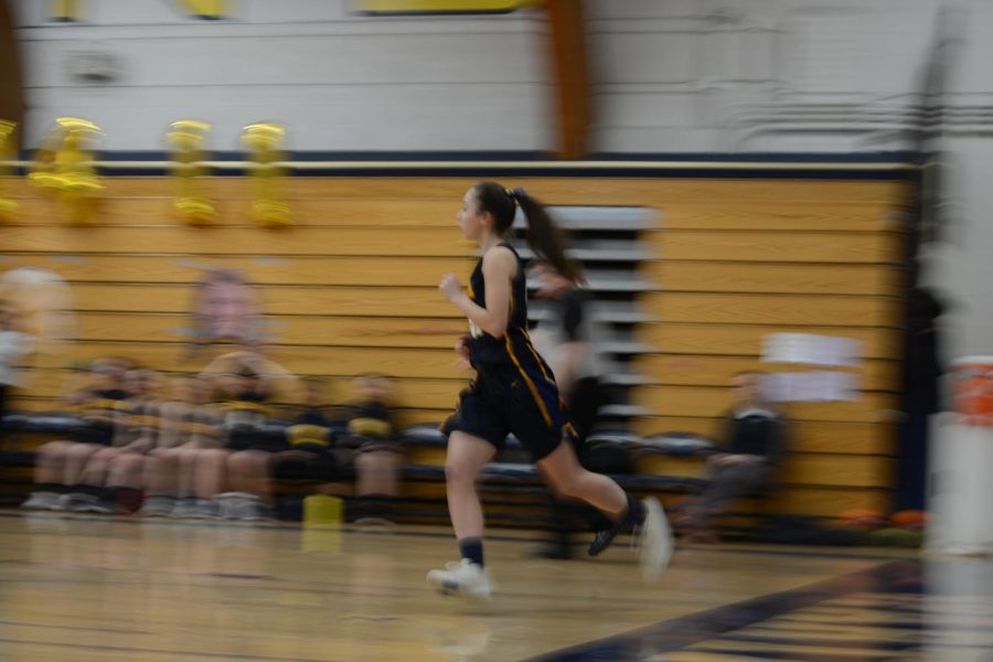Junior Julia Baron races across the court to follow her opponent with the ball. 