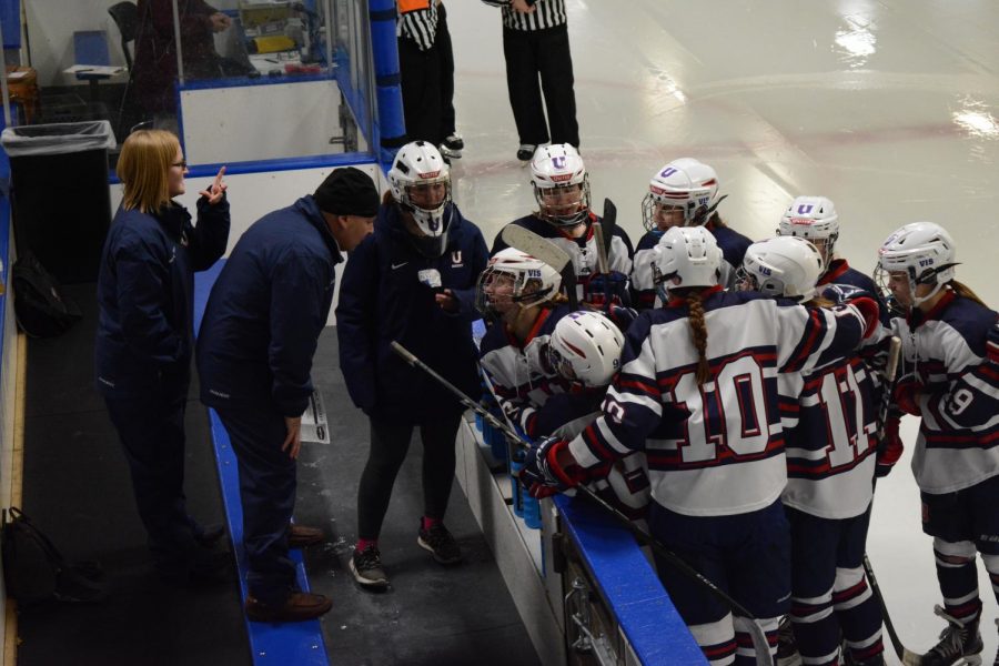 Team members huddle and get advice from their coach.