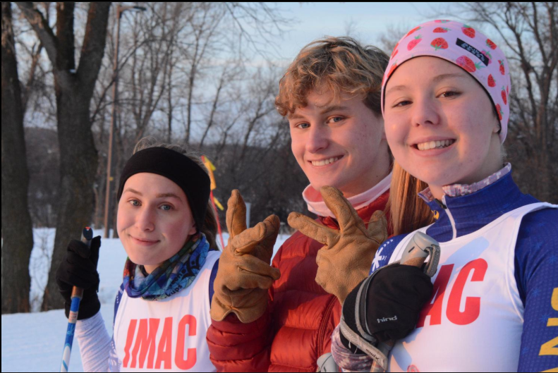 Senior Nordic Ski Captains Lauren Dieperink and Maddy Breton and senior Henrik Schleisman pose for a photo. 