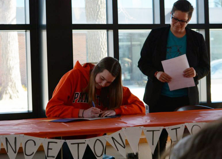 Senior Kathleen Bishop signs the official document to play D1 volleyball at Princeton University. I feel so excited. Im really looking forward to the next four years at Princeton and playing volleyball there. I loved everything about it when I went on my visit and Im super excited for what it has in store, she said. 