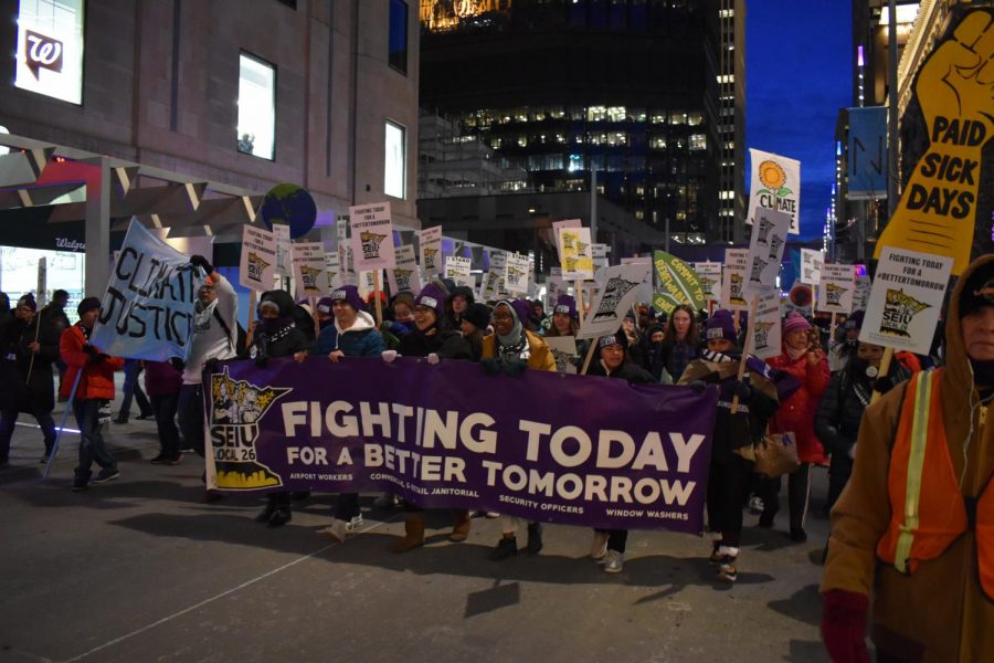 People line up to protest holding signs of a better future.