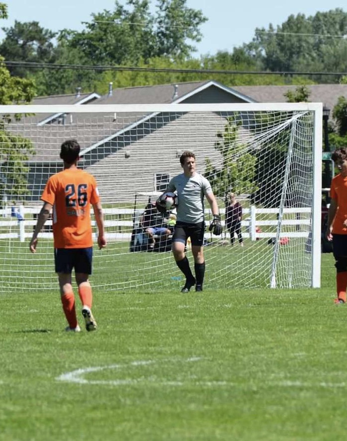 Jack Biggs looks for his team mates to make a pass after making a save on his club team.