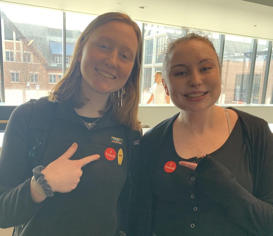 Seniors Paige Indritz and Anna Snider show of a token from Super Tuesday: an I Voted sticker. 