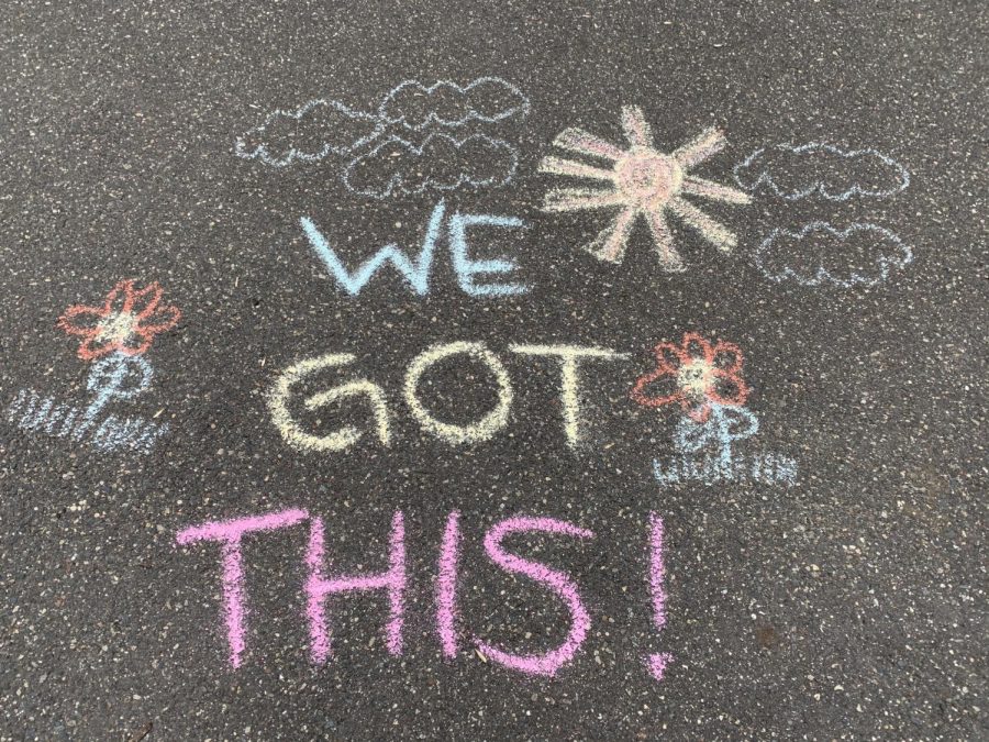 Encouraging messages are written on driveways for people driving past. 