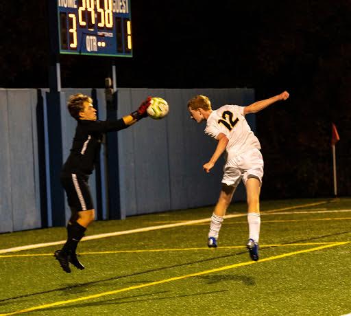 Junior Jack Hlavka heads the ball into Blake's goalie's hands.