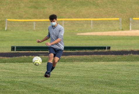 Senior defender Anthony Chen warms up following COVID-19 protocols.