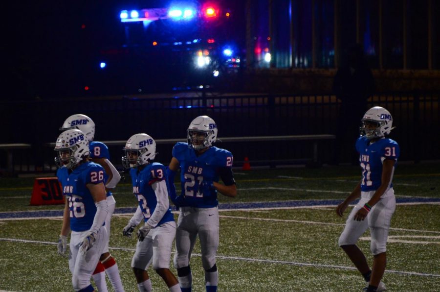 Wolfpack players rush back to the field after a player gets injured. 