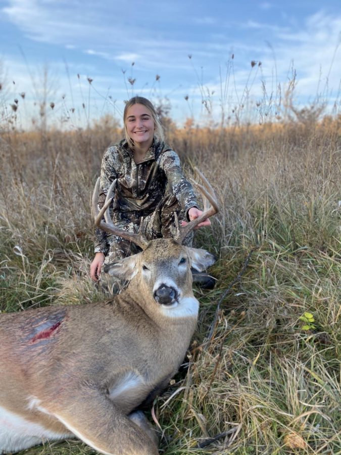 Spaulding showcases the sika stag she shot this season.