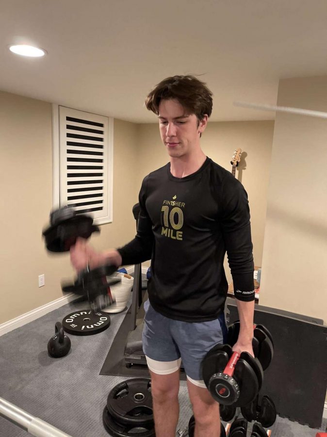 Senior Levi Mellin does a bicep curl during his basketball workout. The team hopes to resume play on Dec. 21 when Gov. Walz’s pause comes to an end.