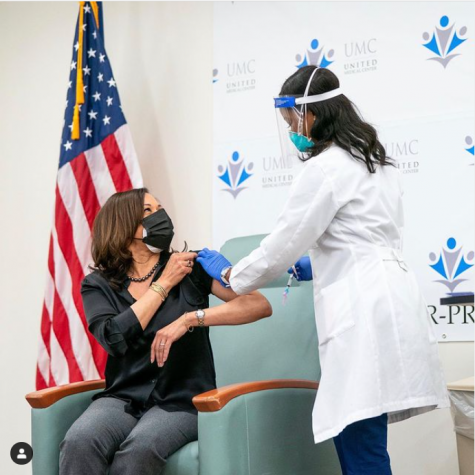 Vice-president elect Kamala Harris receives the first dose of the COVID-19 vaccine in front of press.
