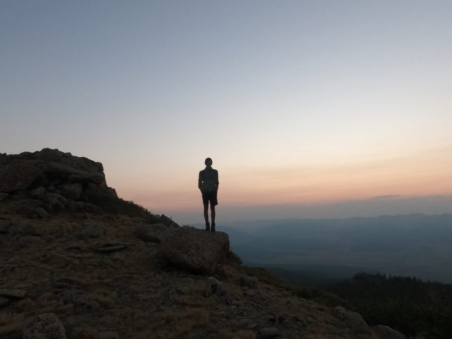 Junior Henry Burkhardt stands on a cliff at his semester away trip. 