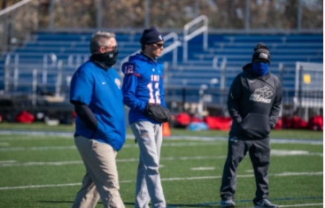 Sidelined quarterback Charlie Johnson observes practice with coaches. He still serves as captain of the team, even though his injury prevents him from playing: “My role has changed as a player but not a leader. Being a captain of the team I am helping all of our guys prepare as well as talking and game-planning with coaches, I am still every part of this team just as I was before, now the only difference is I cant suit up and put the pads on every Friday night,” Johnson said.