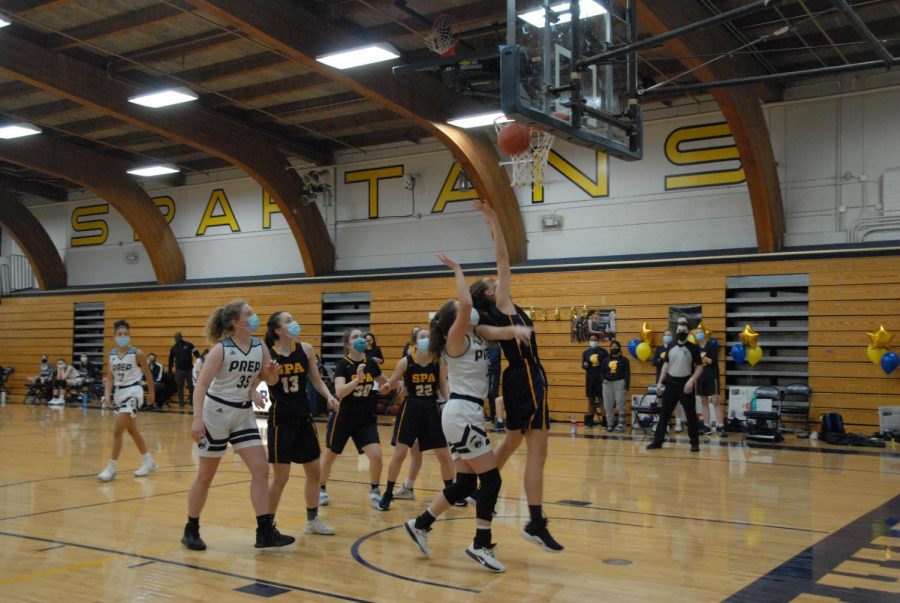 Senior Gabriella Thompson jumps for a rebound with a St. Croix Prep player on her back. Thompson tallied 29 rebounds during the game. 