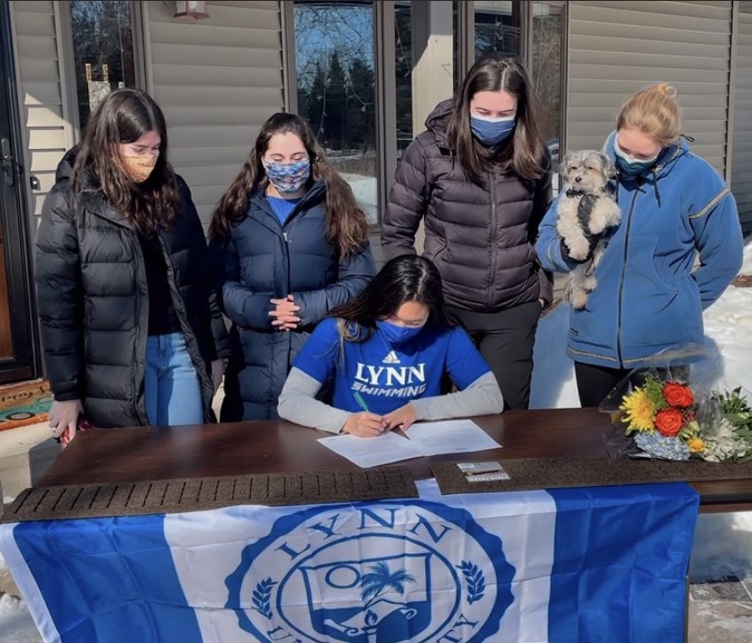 Senior Jasmine White signs the official document to swim for Lynn University.