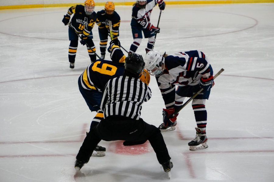 Lucie Bond prepared to take the face-off while her team anxiously watched, waiting for her to make the next move.