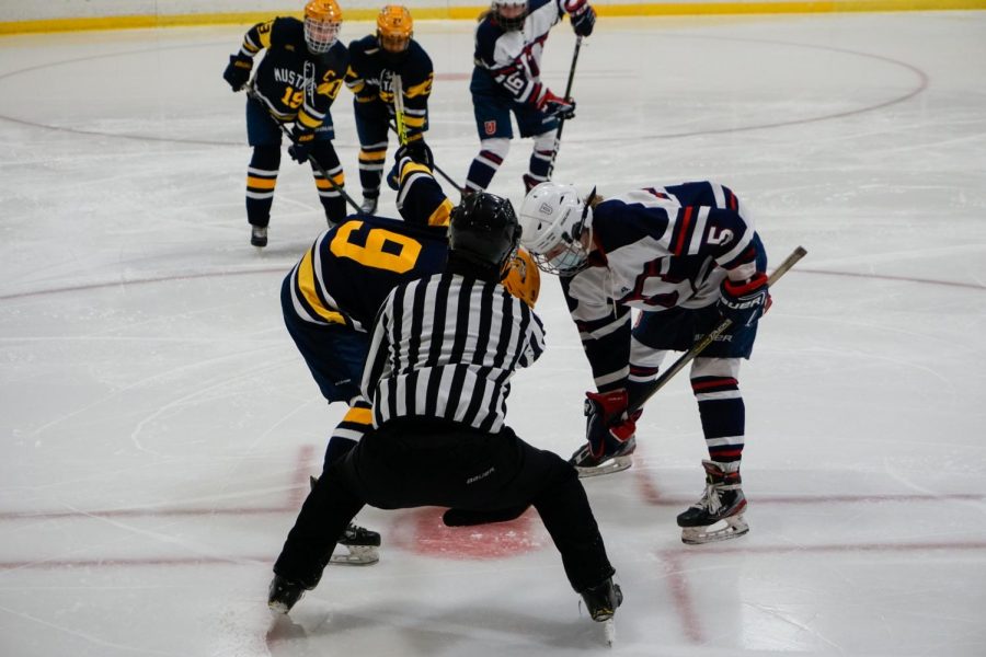 Lucie Bond prepared to take the face-off while her team anxiously watched, waiting for her to make the next move. 