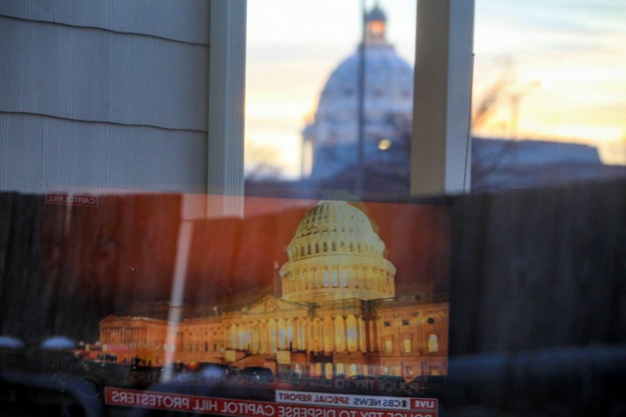 The+U.S.+Capitol+news+coverage+on+January+6+reflected+with+the+Minnesota+State+Capitol.