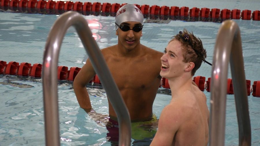 9th graders Connor Overgaard and Rishi Bhargava consult after a very marginal victory in the 100 free. Barghava exclaimed "No way" after coach tells them Overgaard beat his competitor and teammate by a sligh 0.4 seconds.