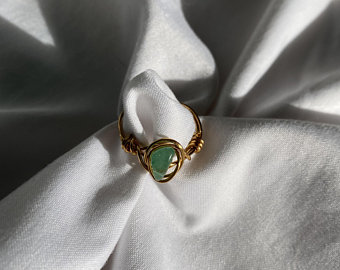 This "Green Aventurine Gemstone Wire-wrapped ring”  can be purchased and found on Kathleen Wosepka’s Etsy account @PlanetaryJewelry.