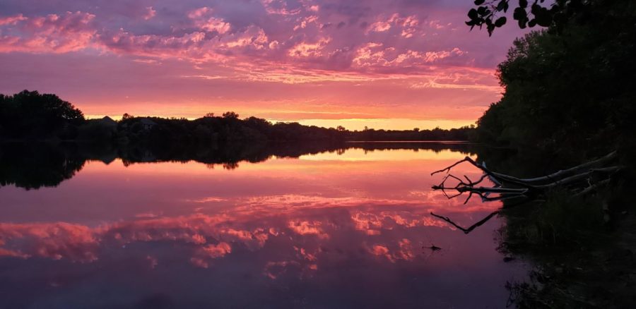 With beautiful clouds rolling in the sky, the sunset turns the lake into an ombre of purple, to pink, and to orange.