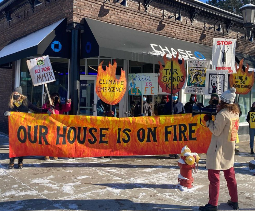 Climate activists in front of Chase Bank protesting against black their financing of the Enbridge company.