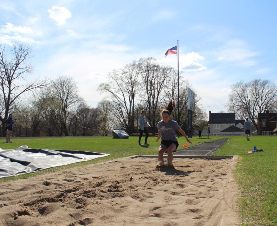 Insley Graupman lands her long jump.