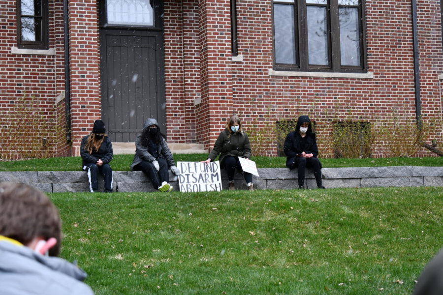 (From left) Senior Evelyn Lillemoe, senior Aman Rahman, junior Ellie Murphy, and senior Gavin Kimmel sit in a minute of silence in honor of police brutality victim Daunte Wright.