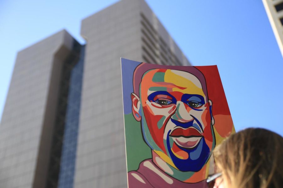 A portrait of George Floyd held up in front of Government Center in Minneapolis, MN. 