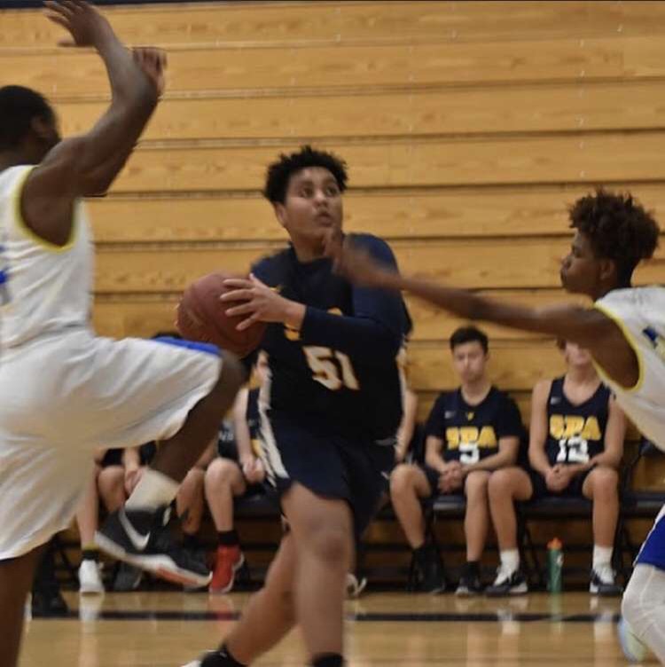 Sophomore Simon Assefa goes up for a contested layup. Even as the SPA basketball season ended before spring break, Assefa is currently playing with the Minnesota Hear through the The Amateur Athletic Union. 