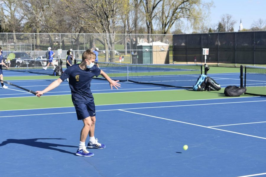 Junior Harry Mahmic hitting the ball back.