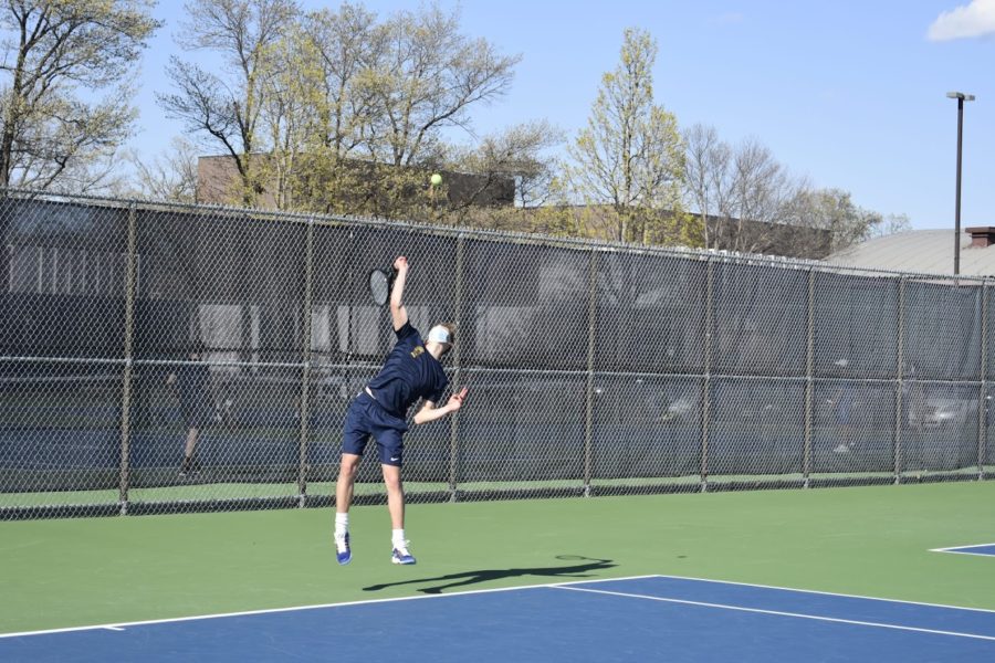 Junior Harry Mahmic serving the ball.