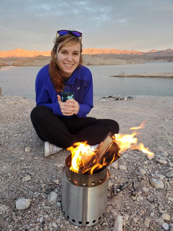 Mckenna Shaw camping on a cold morning by her stove.