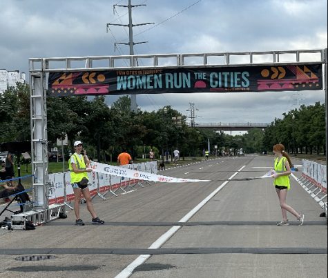 Kate Jacobs assisting setting up the finish line for the Women Run In the Cities marathon. Jacobs had helped the runners for a morning. 