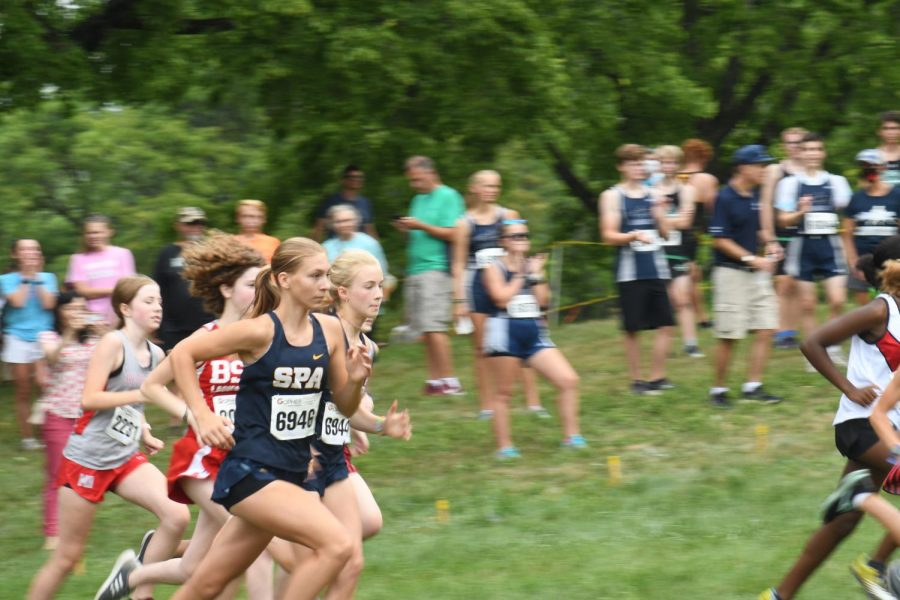 PACE YOURSELF. Freshmen Inga Wing and Helen Townley sprint to the finish line in a 2-mile race. Sophomore Ford Reedy said, “My favorite part of being on the team is everybody on it.”