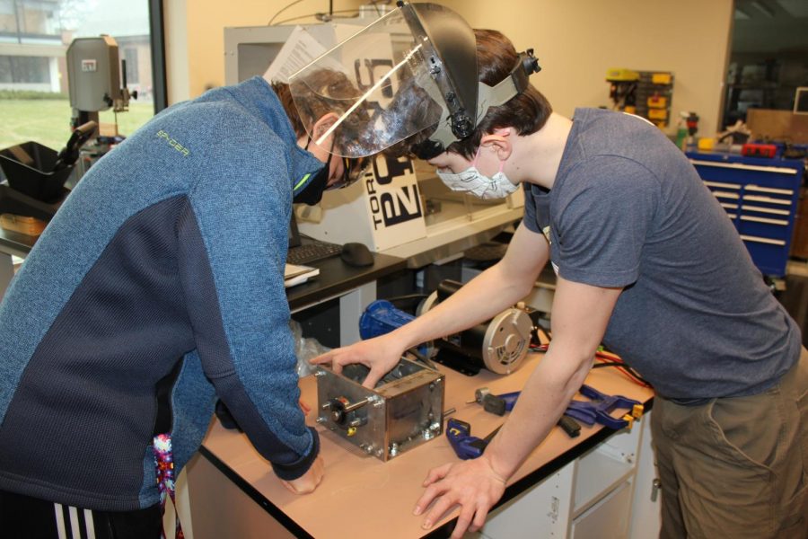 Senior Dante Gilbert works on the robotics team newest creation, which was used in last years competition. Senior Naci Konar-Steenberg said, “The motto [Of FIRST] is ‘Gracious Professionalism’, and that heavily focuses on trying to remain professional, mainly trying your best at robotics, while also trying to remain gracious in kind to team members, yourself, and the environment in the local engineering community.