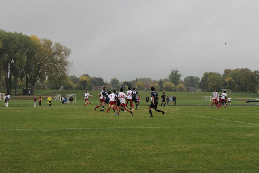 Spartans compete to gain possession of the ball after a free kick.