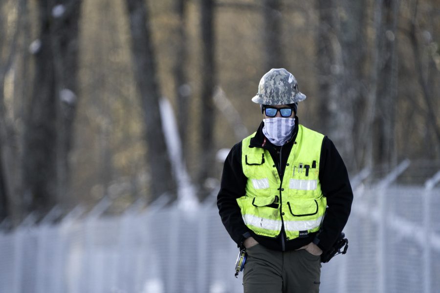 An Enbridge Line 3 construction worker walks on-site in Aitkin County, MN. 
