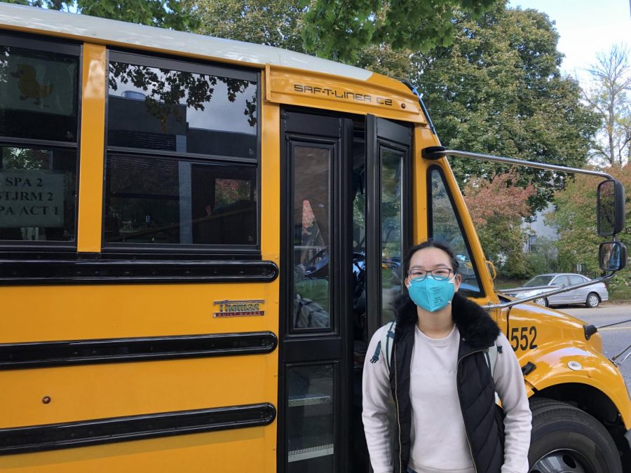 THANKS FOR THE RIDE. Freshman Deling Chen stands in front of a school bus as she waits for the doors to open. Although there has been a bus driver shortage devastating school schedules throughout the nation, Saint Paul Academy hasn’t had to cancel any bus routes. “[Having to cancel bus routes] hasn’t been too difficult for SPA,” Director of Transportation Melissa Douden said, “For other schools it’s been a very big challenge.”
