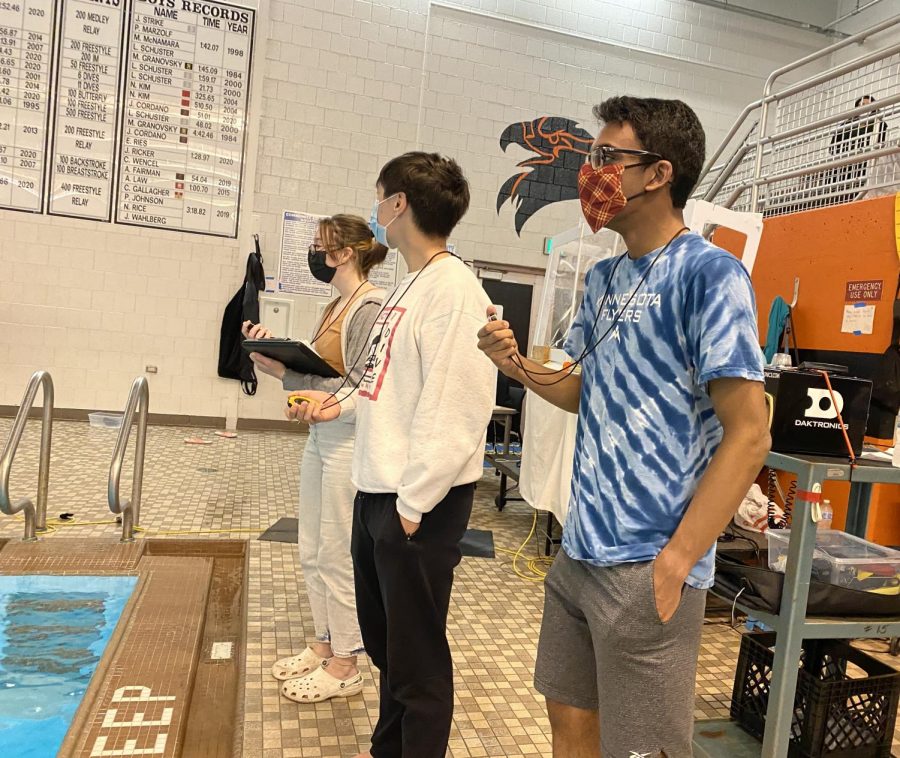 ON YOUR MARKS. Girls Swim and Dive Team manager Rishi Bhargava records a
race during practice. “We time with stopwatches and we are able to help [coach] Katy out with whatever she needs,” he said.