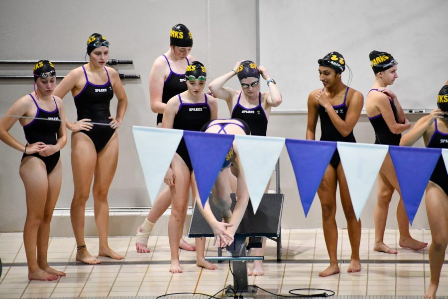 The varsity girls prepare for their first relay of the night, the 200 Medley.