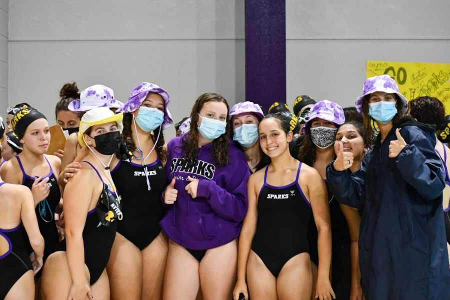 Before the meet starts, the Sparks get together to do their cheer. The SPARKS are a co-op swim and dive team with Highland Park. 