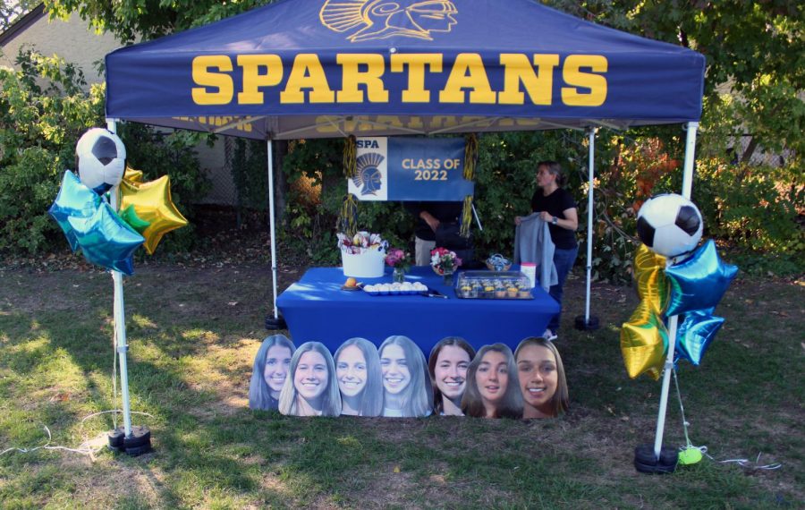 The stand shows off the snacks and posters the seniors received after the game.