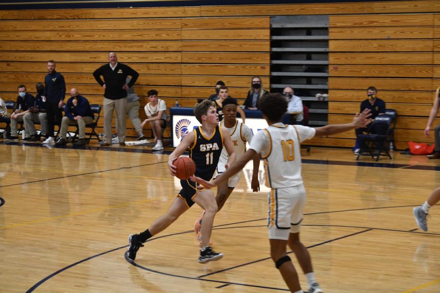 Senior Brandt Baskerville drives to the hoop to secure the contested layup.