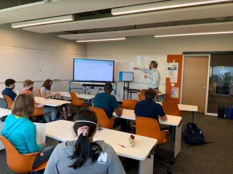 WATCH AND LEARN. Math team coach Dan O'Laughlin shows the team easier and quicker ways to solve difficult math questions.