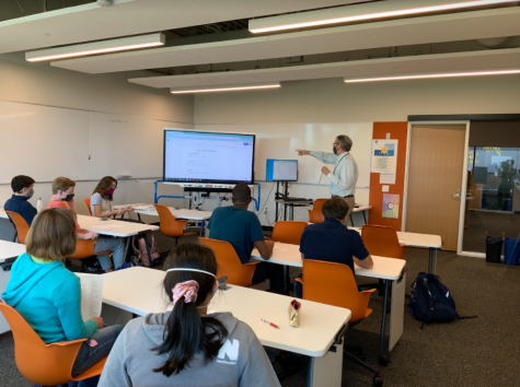 WATCH AND LEARN. Math team coach Dan OLaughlin shows the team easier and quicker ways to solve difficult math questions.