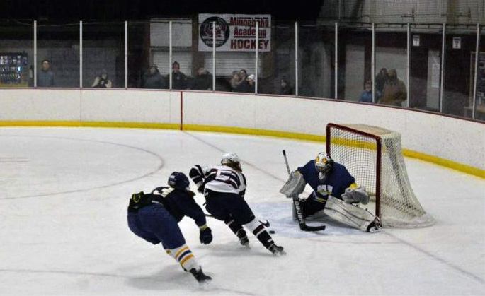 Bond beats Windom defender to the net, taking a backhand shot. 