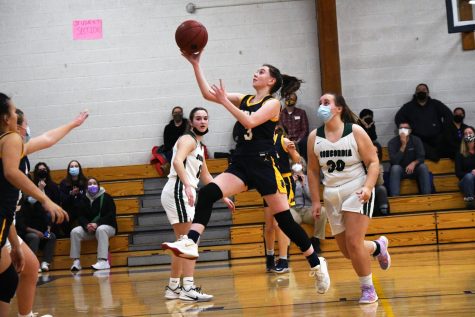 DRIVE TO THE HOOP. Shooting guard Catherine Hooley goes in for a lay-up. Hooley is often a high scorer. 