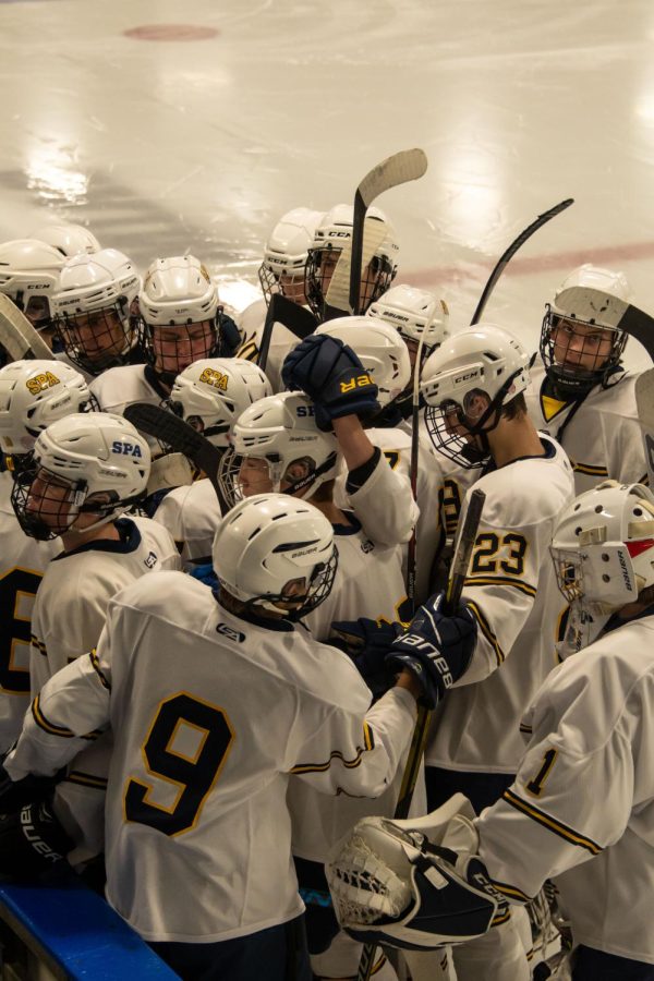 TEAM HUDDLE. Spartans huddled around the bench as they prepare for their first regular-season game against Simley on Nov. 30. The final score was 0-2. 
