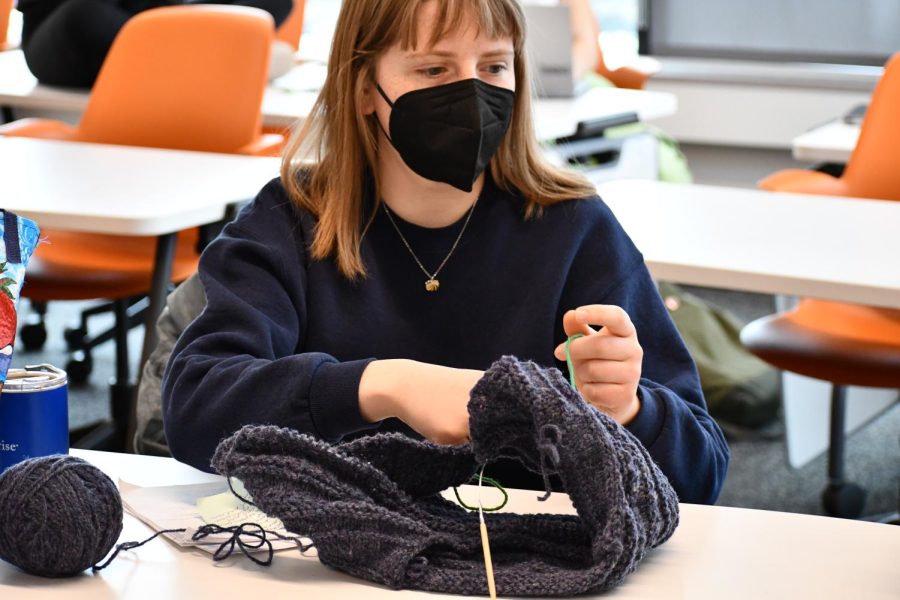 Senior Eleanor Smith utilizes the Knitwits club meeting time to work on a cozy sweater. 