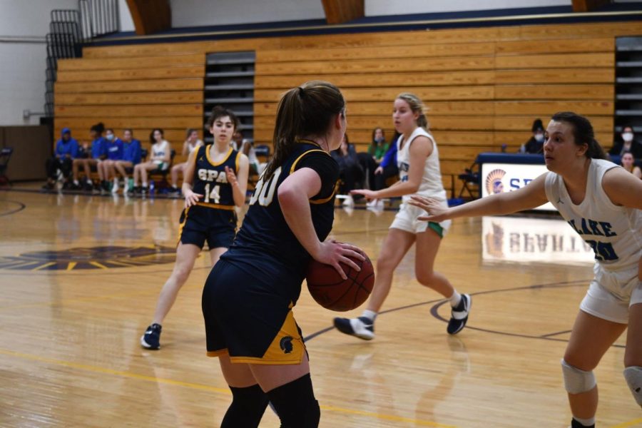 PROTECTIVE POSSESSION. Captain Lindsay Browne gets in her protective stance as she waits for the right opportunity to pass the ball to one of her teammates. Browne finds that the key to running a successful play is being patient when the team has possession and making sure to communicate. 